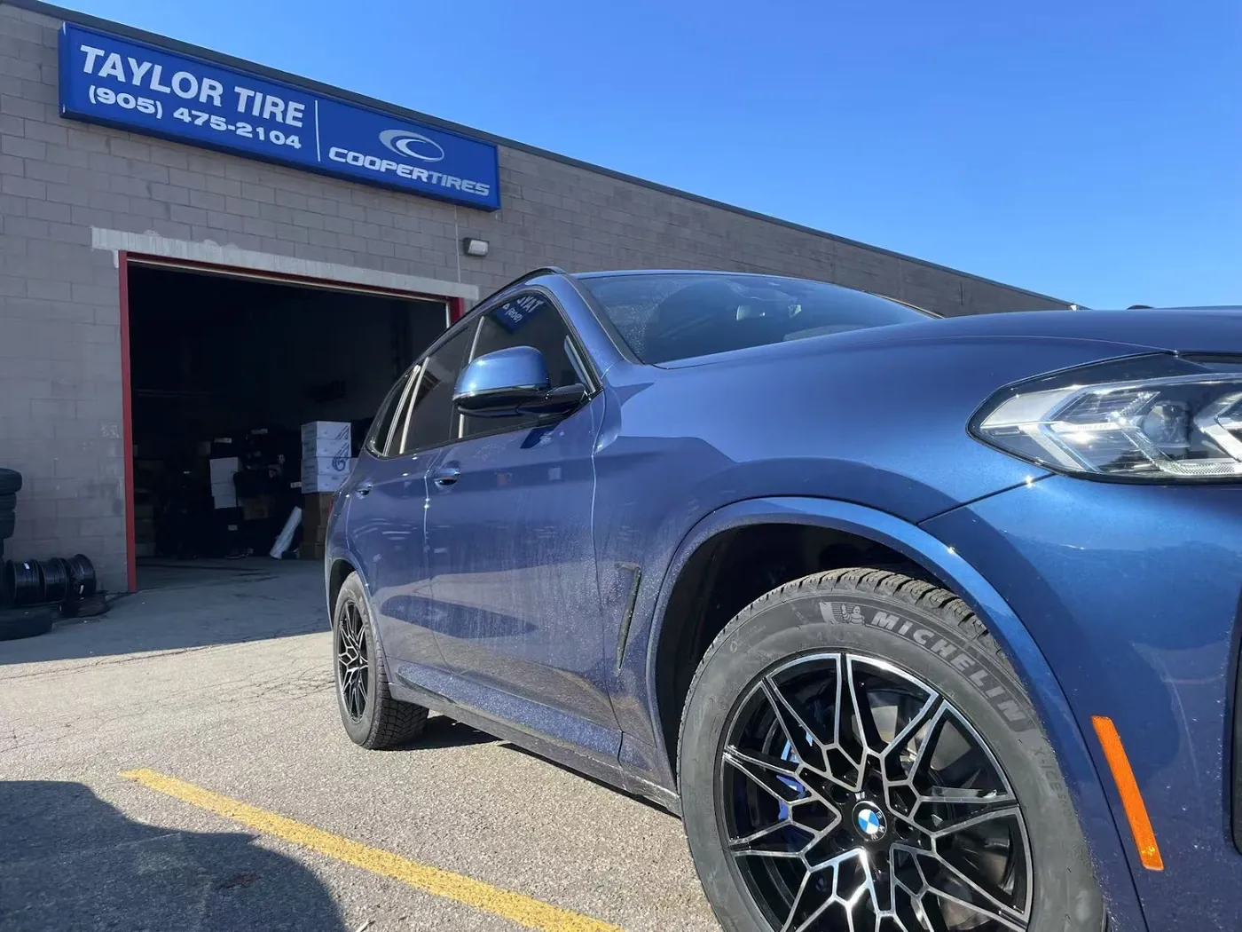 BMW X4 M on Michelin tires leaving the Taylor Tire shop door in Markham