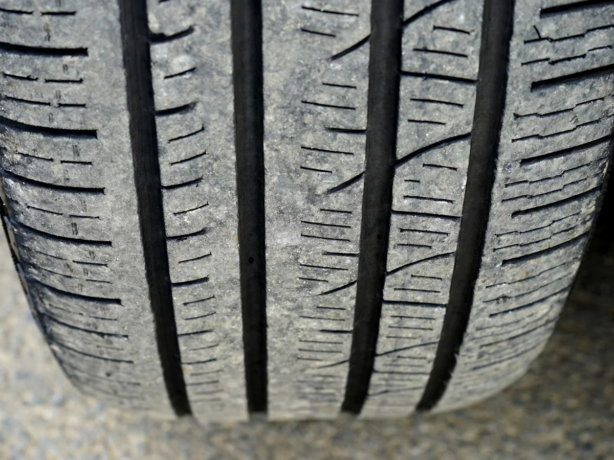 Close-up photograph of real tire tread used as evidence when checking for uneven alignment-related wear.